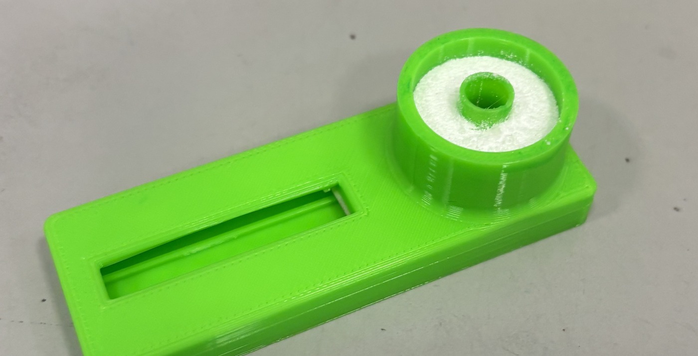 3D-printed cassette body showing the annular heating chamber around the central sample well