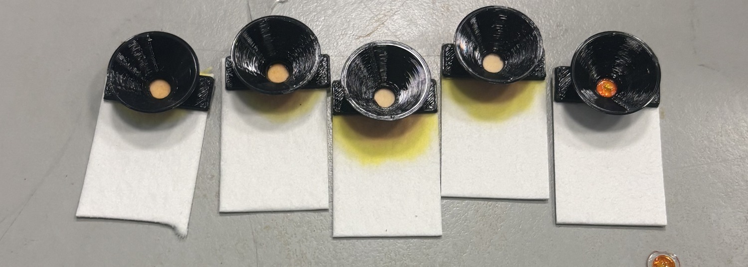 Five valve units after breakthrough showing dye fronts of differing quality on the sample pads