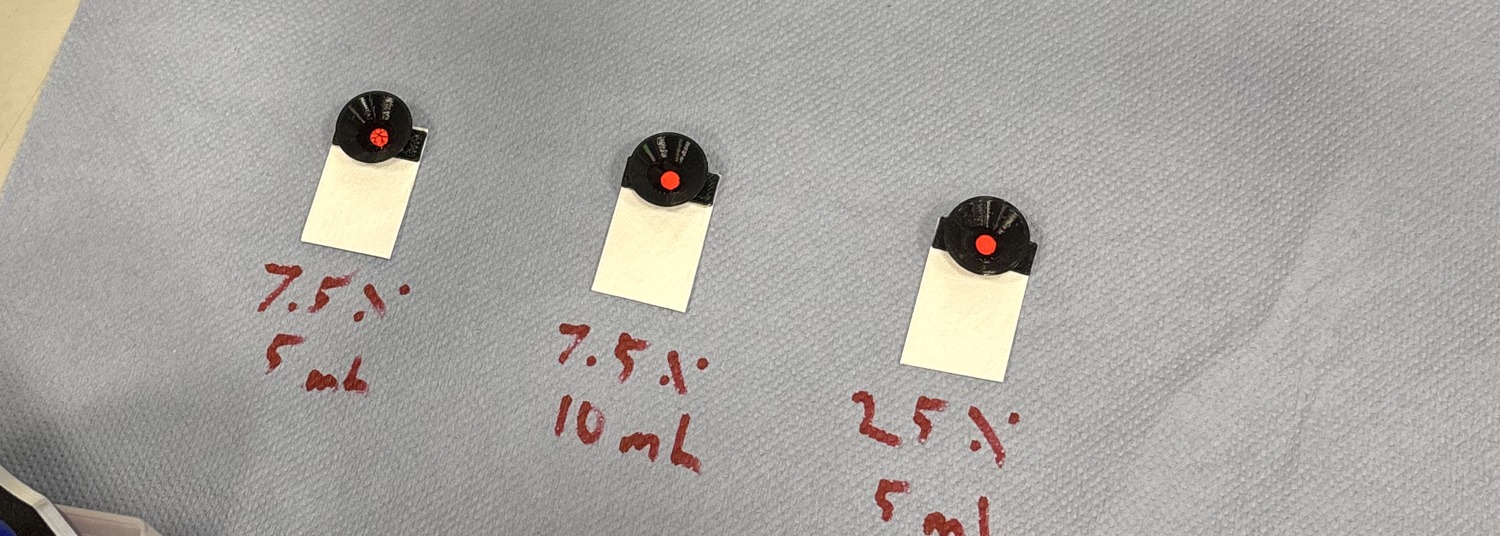Three valve units mid-test with dye fully retained and sample pads dry, labeled by casting condition